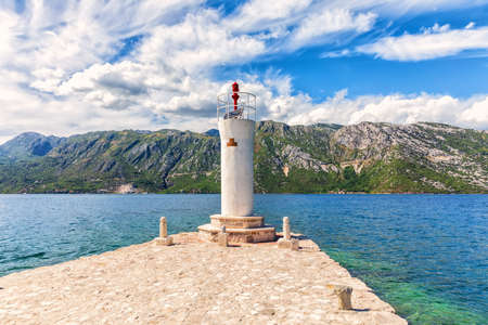 Lighthouse by the Church of Our Lady of the Rocks in the Adriatic sea, Bay of Kotor near Perast, Montenegro.の写真素材
