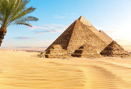 Pyramids of Egypt at sunset in the sunny desert of Giza, famous Wonder of the Worldの写真素材