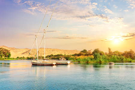 View on the Nile and the boats at sunset, Aswan, Egypt.の写真素材