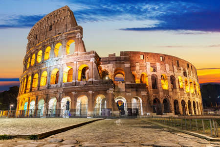 The Coliseum illuminated at sunrise, front view, Rome, Italyの写真素材