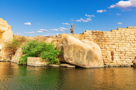 Ancient rocks with Hieroglyphic carvings on the bank of the Nile in Aswan, Egypt.の写真素材