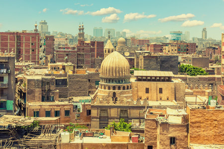 Dome of the mosque in front of old buildings of Cairo downtown, exclusive view of Egypt.