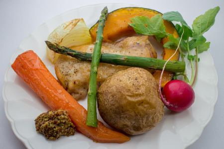 Roasted vegetables and chicken steakの写真素材