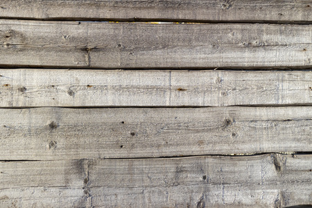 Wooden fence of horizontal planks on a sunny day.