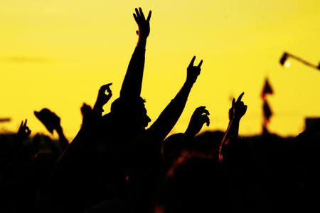 people celebrating on an open air shillouettesの写真素材