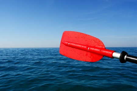close-up of a red paddle outside in the oceanの写真素材
