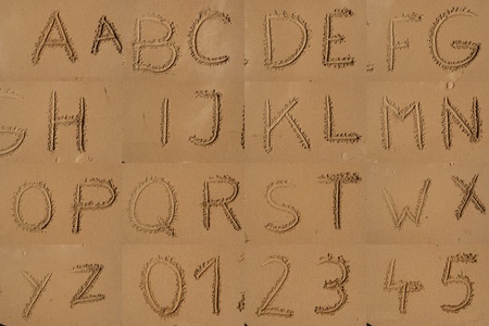 The alphabet written in sand on a beach.の写真素材