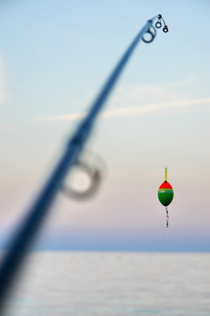 Fishing pole waiting to be cast, with line and sinkerの写真素材