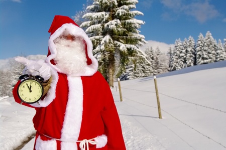 Santa Claus, Father Christmas holds watch clockの写真素材