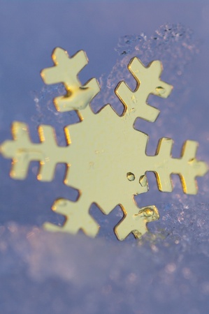 golden snow stars on a real snowy icy surfaceの写真素材