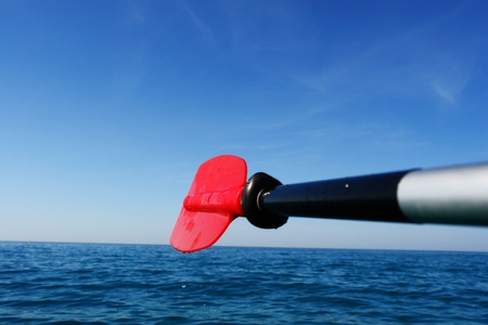 close-up of a red paddle outside in the oceanの写真素材