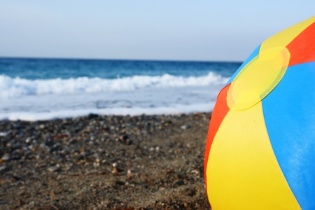 bright multicolored beach ball on the beachの写真素材