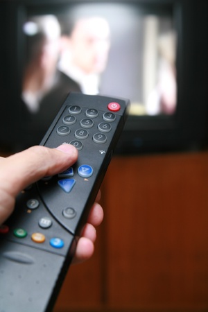 a remote control pointing to a tv.