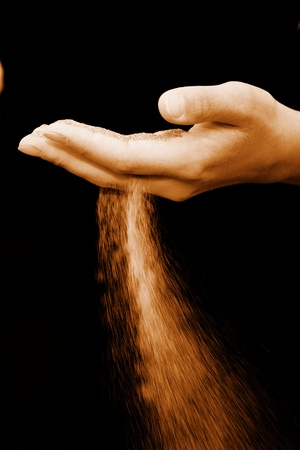 sand running through hands as a symbol for time runningの写真素材