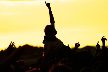 people celebrating on an open air silhouettesの写真素材