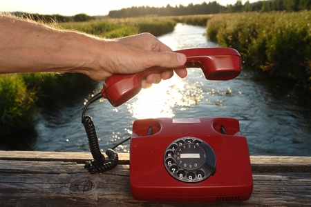red phone in landscapeの写真素材