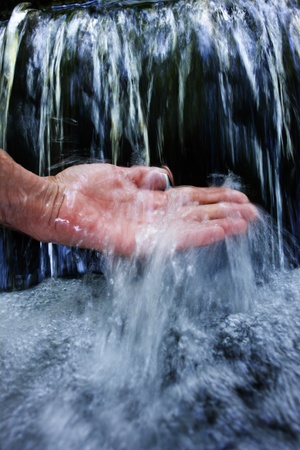 close-up of a hand under clear waterの写真素材