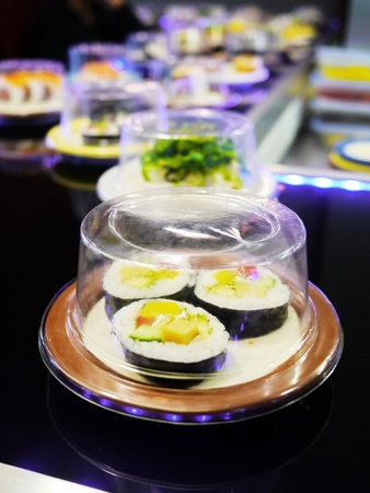 sushi belt with sushi dishes in a sushi barの写真素材