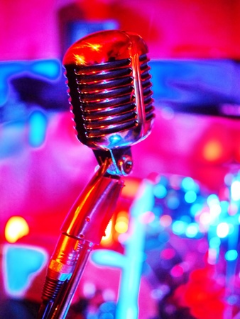 classic microphone with pinkt lighting on backgroundの写真素材