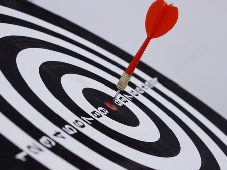 One dart is hitting perfectly on the black dart board