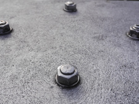 gray metal screws and nuts in the structureの写真素材