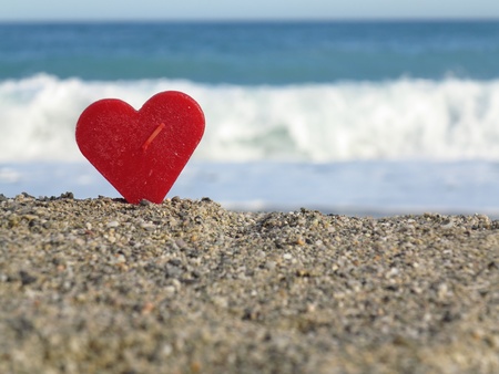 Red heart on white sand beachの写真素材