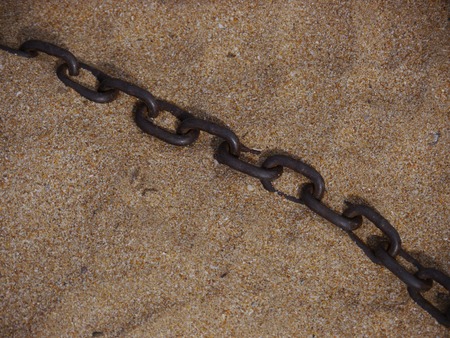 Chain on the beach in sandの写真素材