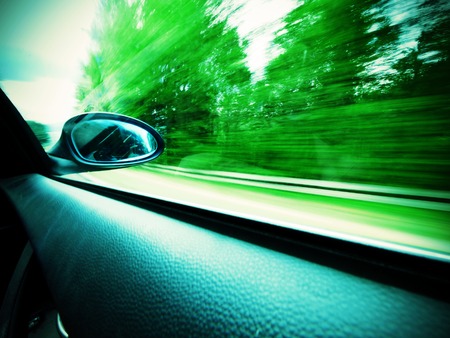car and rear view mirror on the road