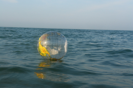 Globe ball at the ocean. on a sunny dayの写真素材