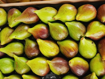Display of fresh figs at a fruit market. Can be used as a healthy food background.