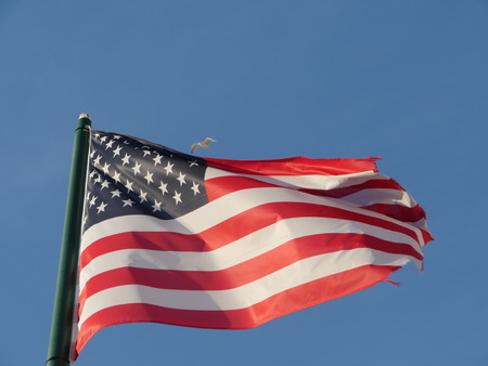American flag against blue skyの写真素材