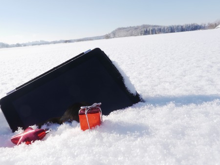 Christmas xmas shopping with digital tablet outsideの写真素材