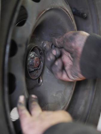 mechanic changing a wheel of a carの写真素材