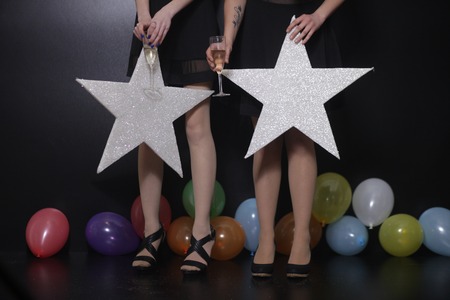 Young beautiful woman standing with star and balloonsの写真素材