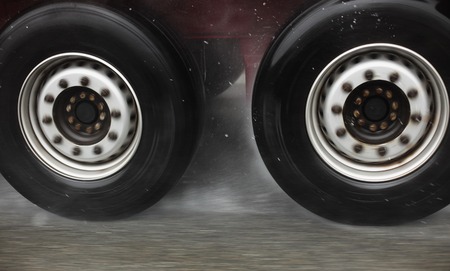 Fast truck wheels on the road hydroplaningの写真素材