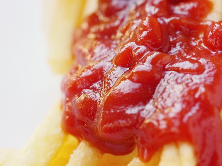 French fries with ketchup on a white backgroundの写真素材