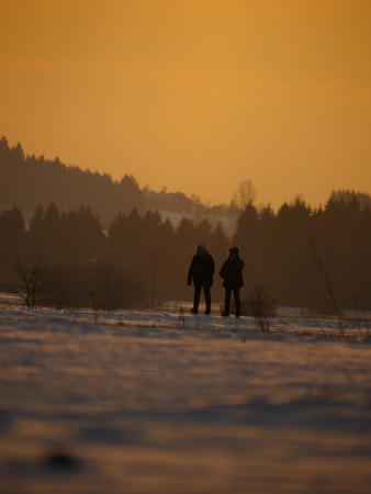 a couple have a walk through a misty landscapeの写真素材