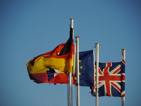 three flags are flowing in the wind