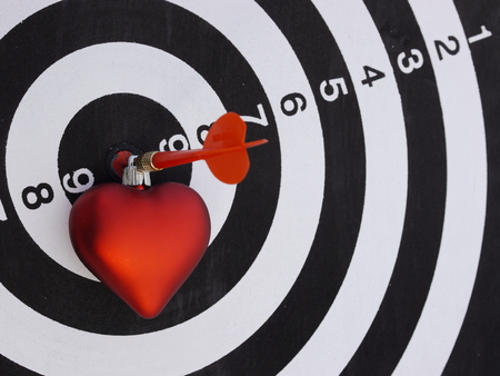 One dart is hitting perfectly on the black dart boardの写真素材