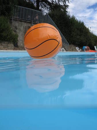 a basketball on clear blue waterの写真素材
