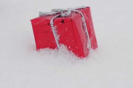 Christmas decoration outside in real snow during snowfallの写真素材