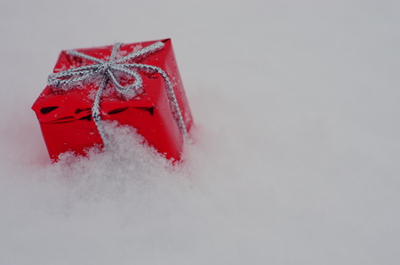 Christmas decoration outside in real snow during snowfallの写真素材
