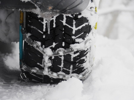 Snow chains outside at a wheel in winter