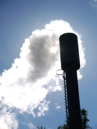 industrial smoke from chimney on blue sky