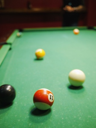 Billiard balls in a green pool tableの写真素材