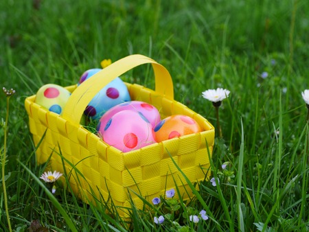 a colourful easter basket on a lawn