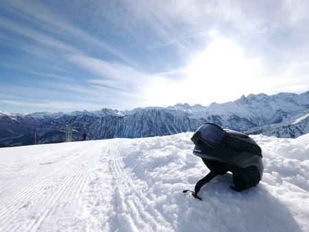 a black ski helmet on a slopeの写真素材