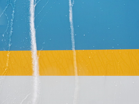Frozen water lines on colorful wall in winter