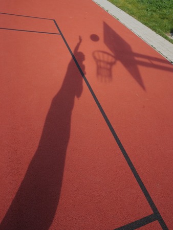 basketball player shooting on red court