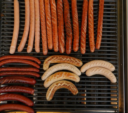 Grilling sausages on barbecue grill. Selective focusの写真素材